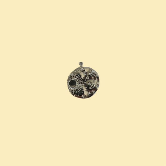 Round charm with moon, star and sun
